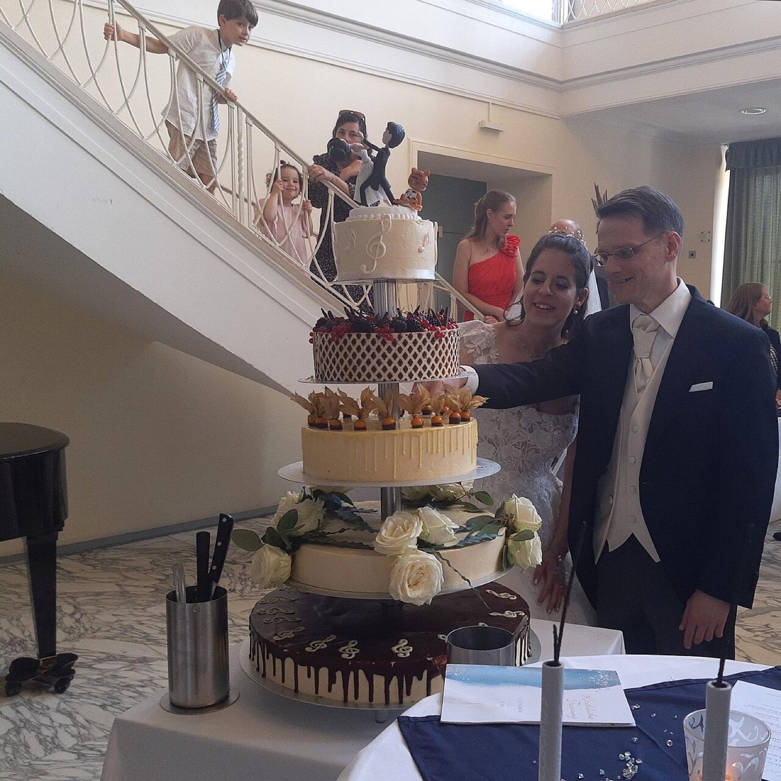A couple cutting a wedding cake