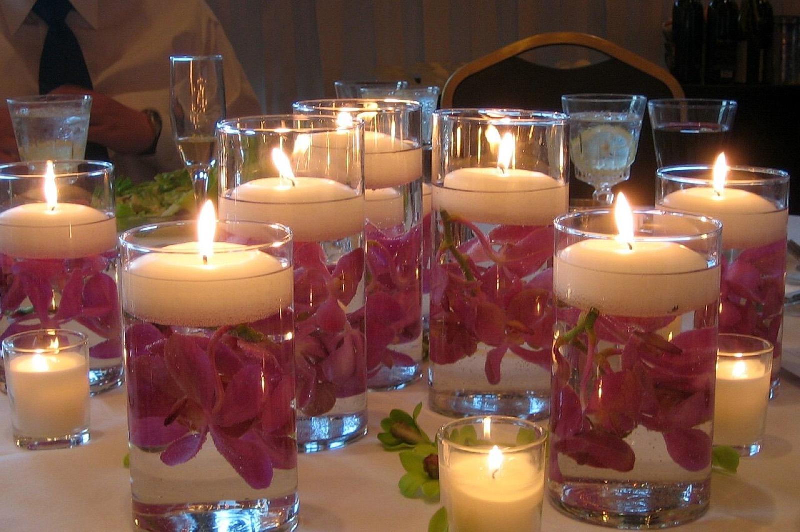 Floating candles and petals in glass vases