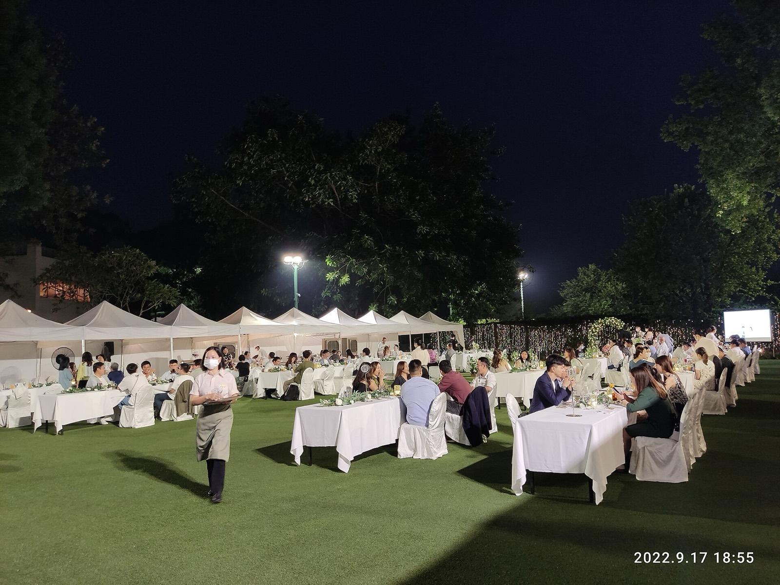 An outdoor dinner on a lawn at night