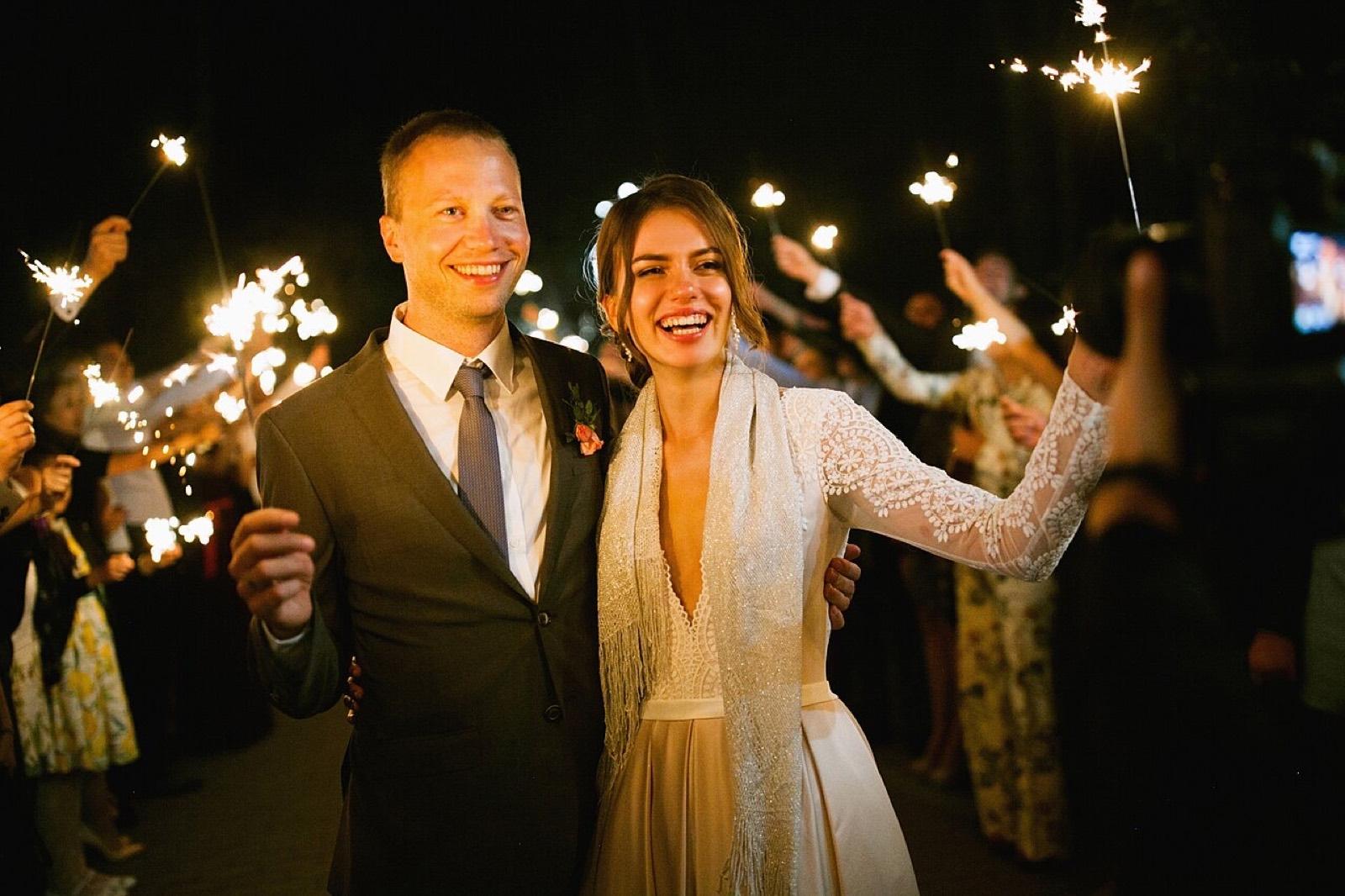 A couple leaving their reception through sparklers